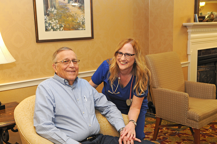 Smiling nurse and patient seated together in cozy setting.