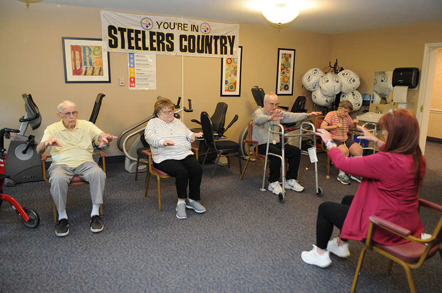 Seniors exercising together in a community center.