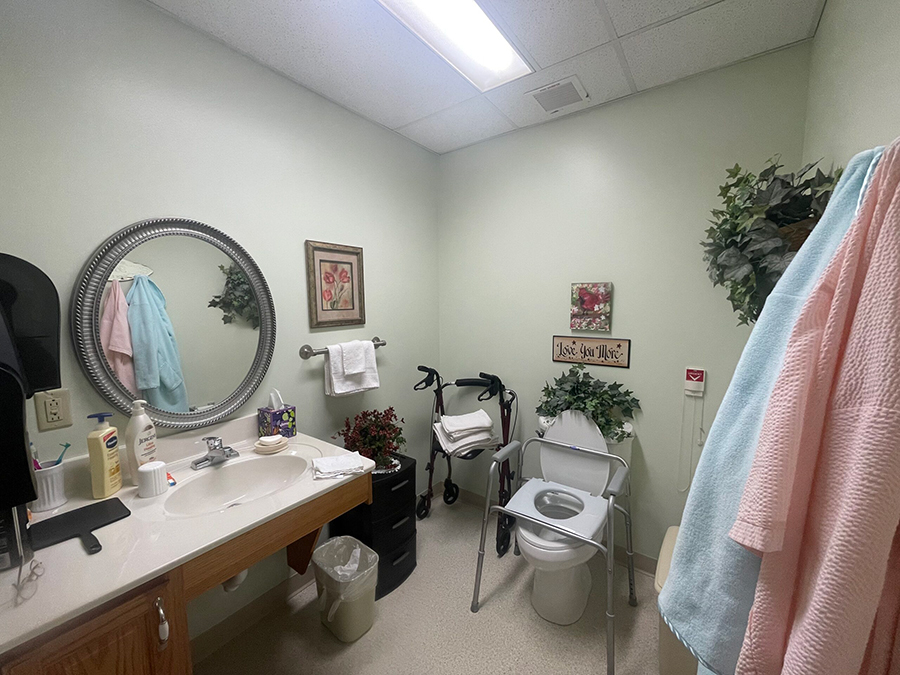 Clean, well-decorated bathroom with accessible features and towels.