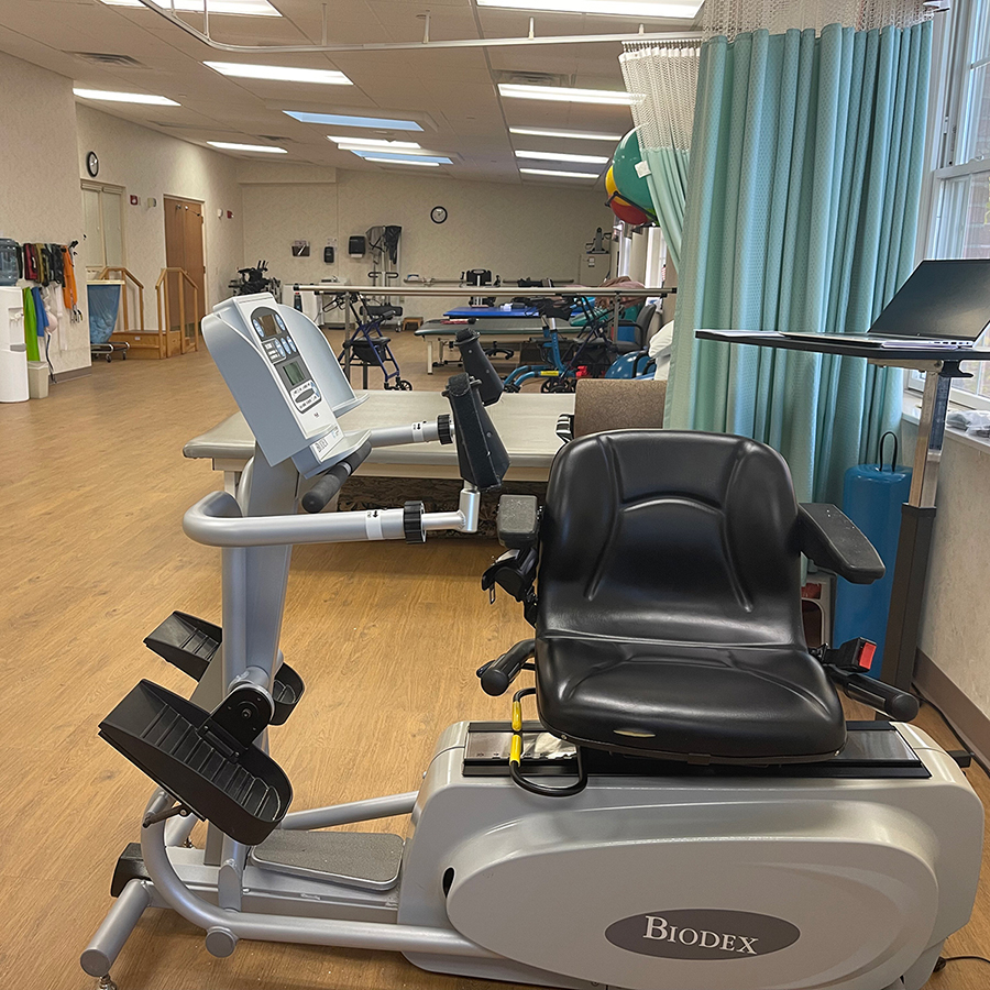 Rehabilitation area with exercise bike and therapy equipment.