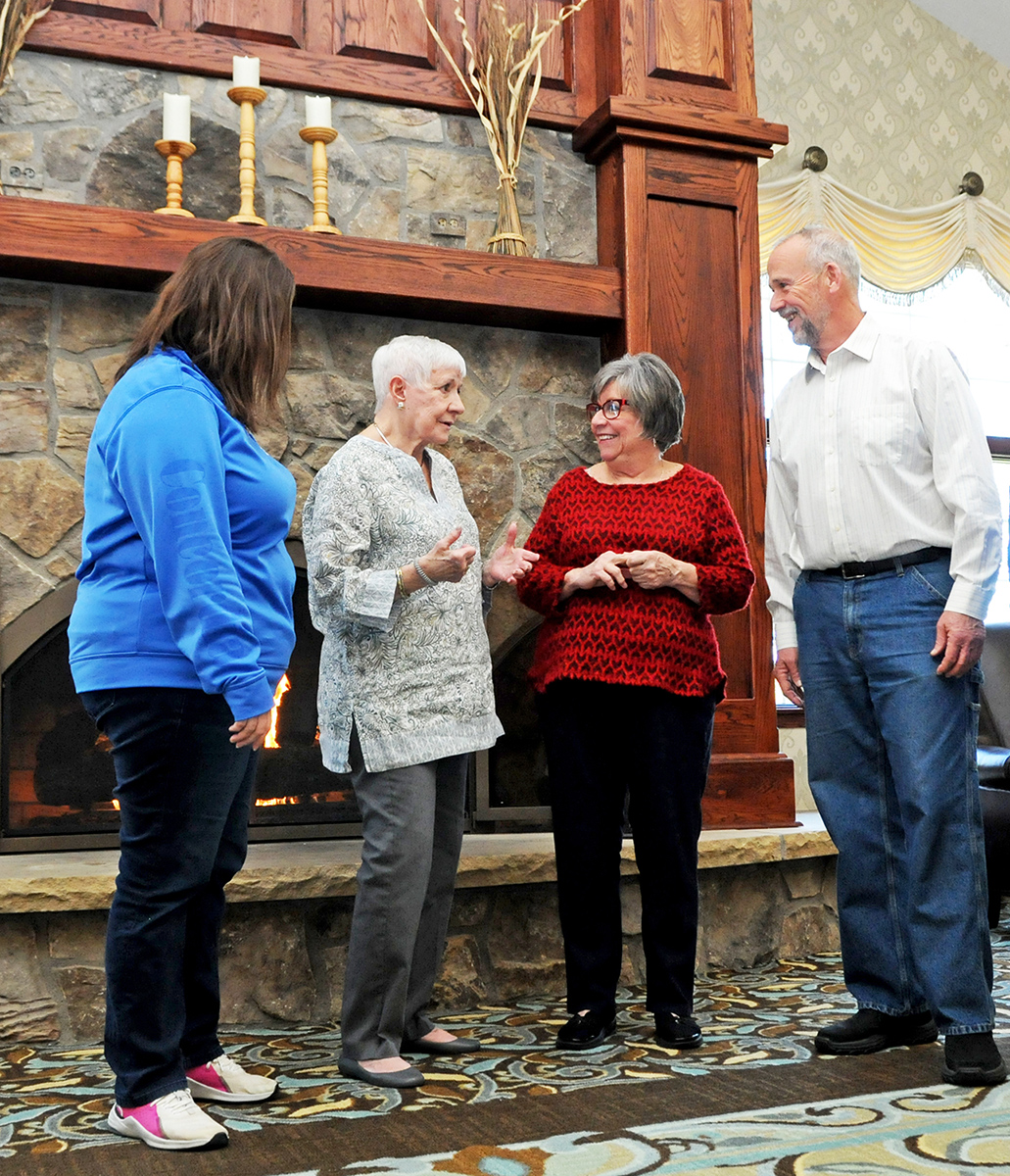 Staff and residents smiling having a conversation