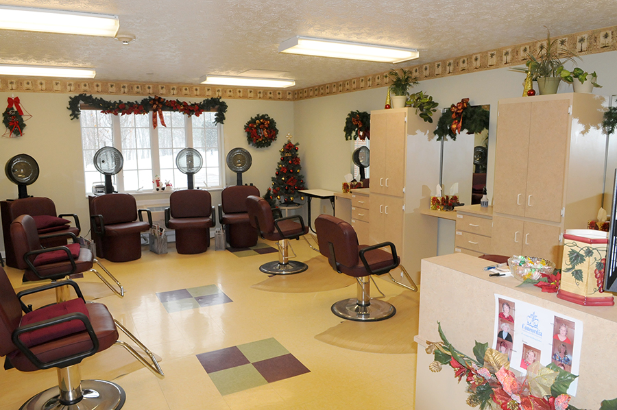 Hair salon decorated for the holidays with chairs and mirrors.