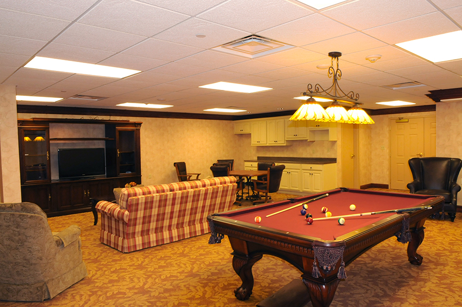 Cozy recreation room with billiards and casual seating area.
