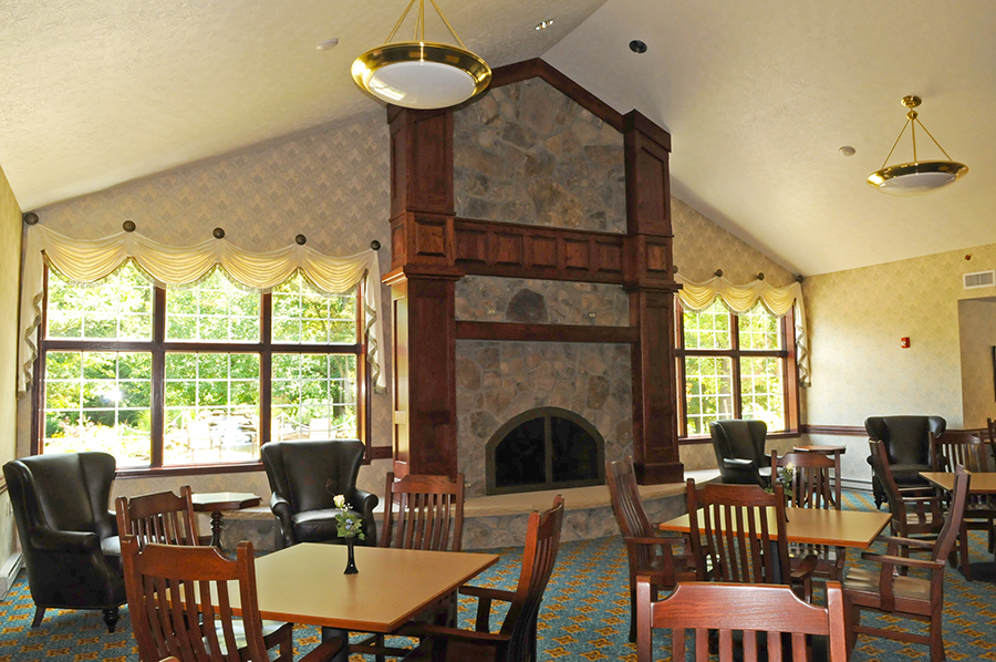 Cozy seating area with fireplace and large windows.