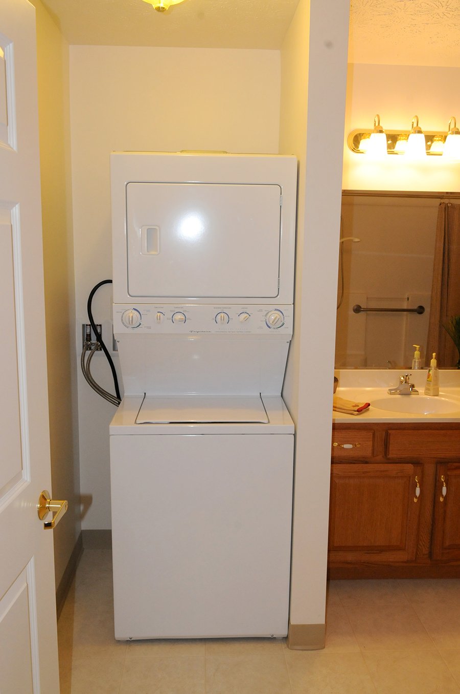 Stacked washer and dryer in a small bathroom space.