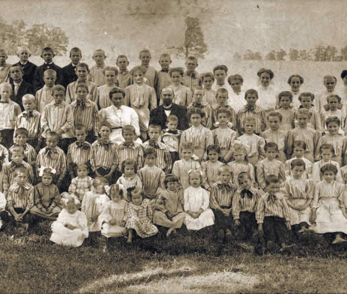 Large group of children and adults, vintage photo.