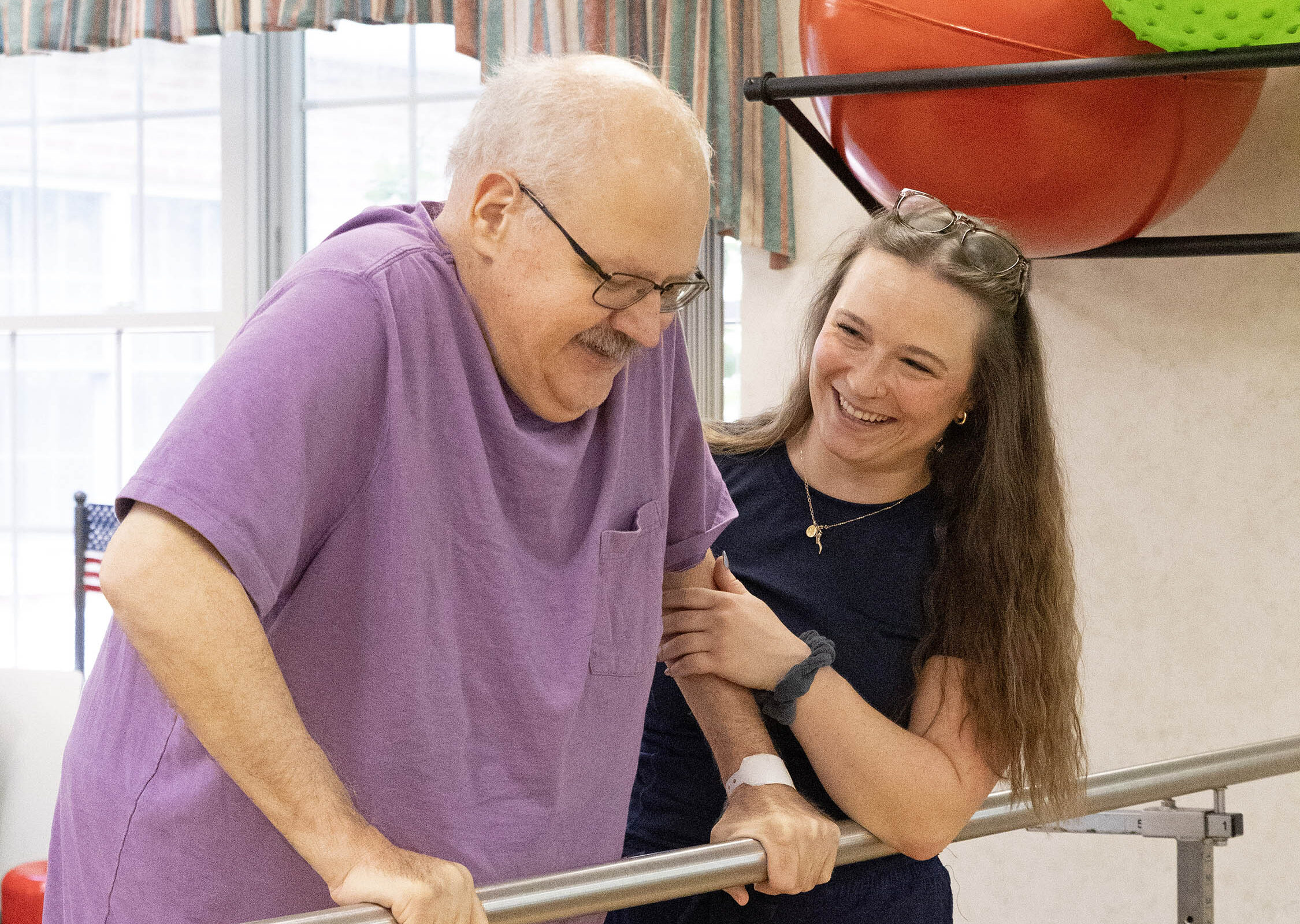 Man receiving assistance during physical therapy session.