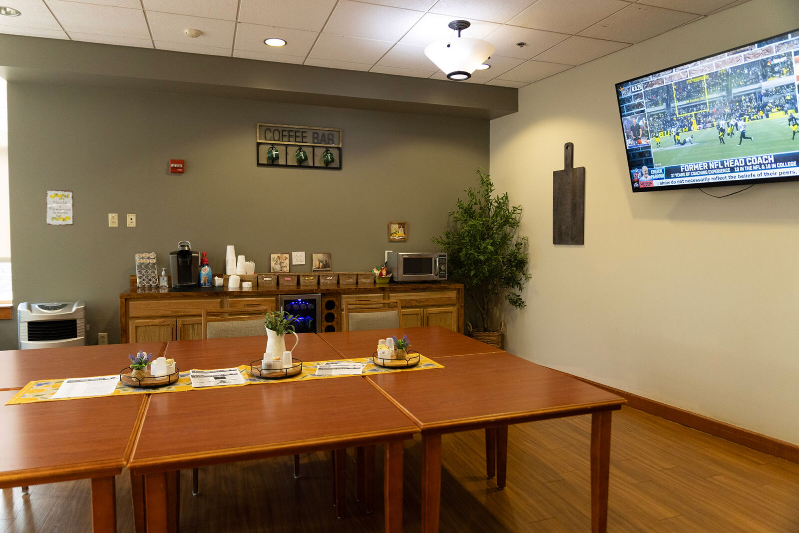 Cozy room with coffee bar and TV, inviting atmosphere.