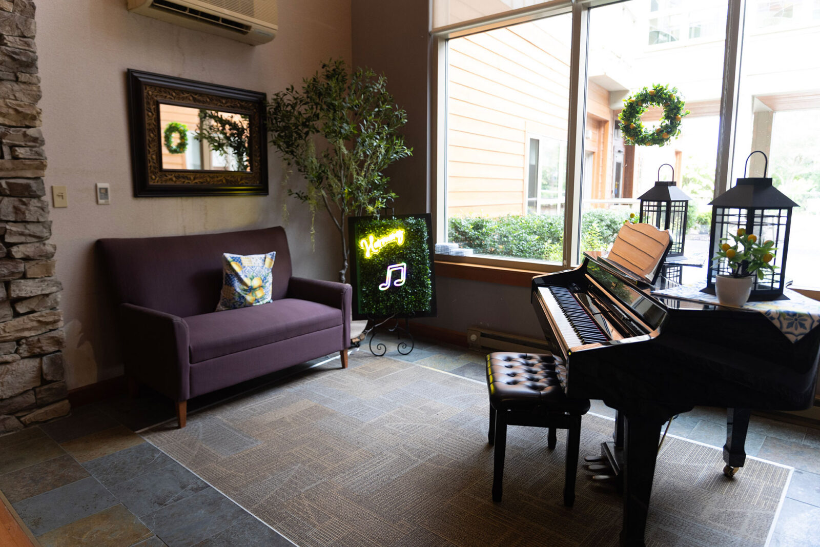 Cozy room with piano, couch, and green decorations.