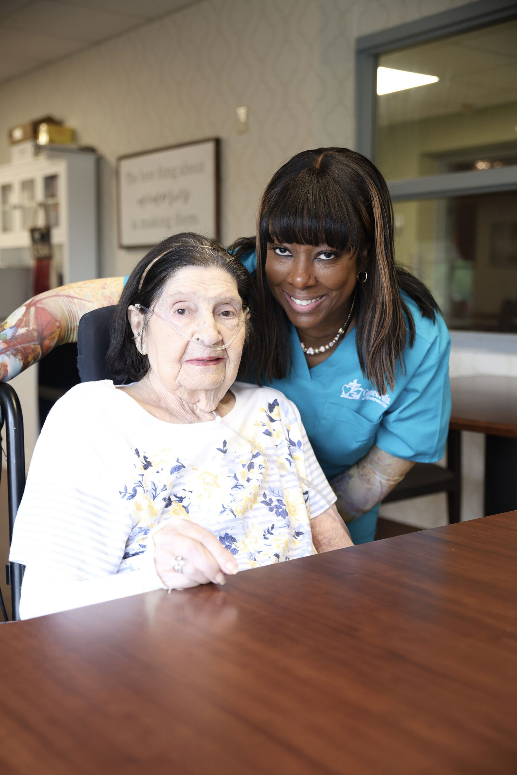 Two women smiling together in a comfortable setting.