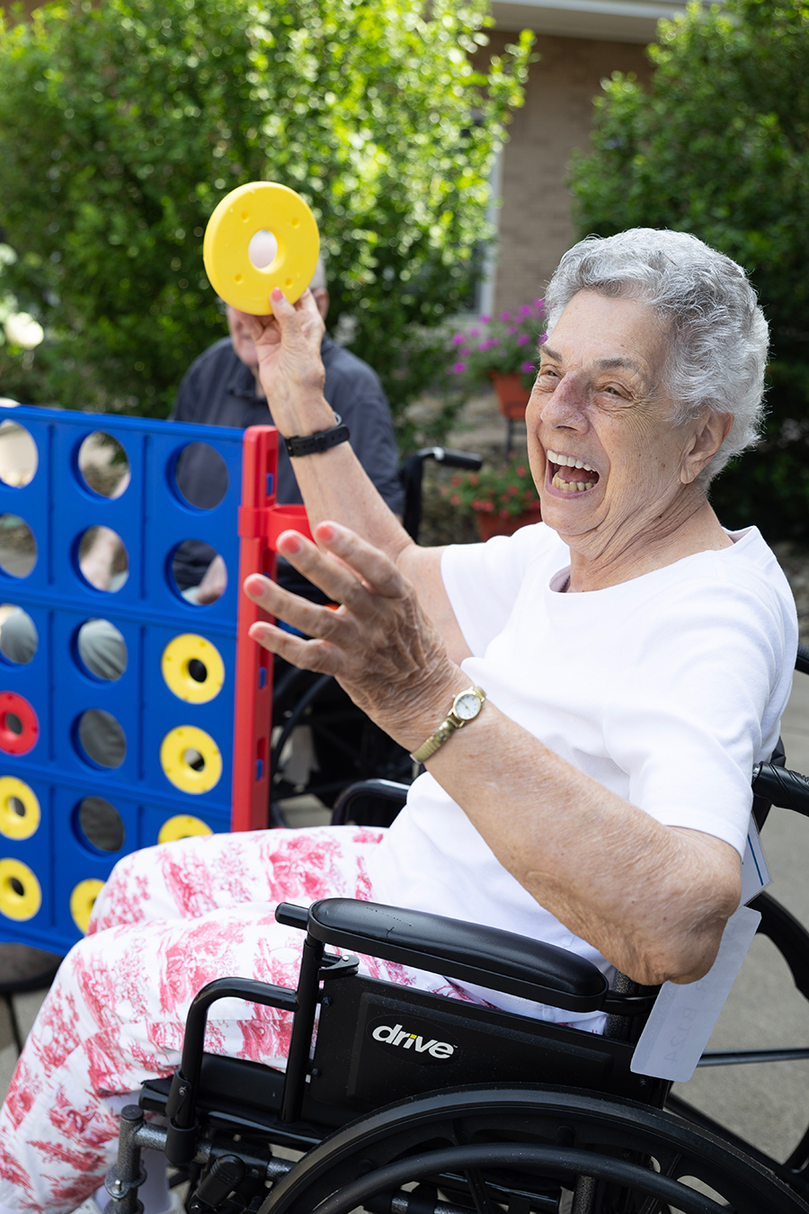 Joyful woman playing a game while seated in a wheelchair.