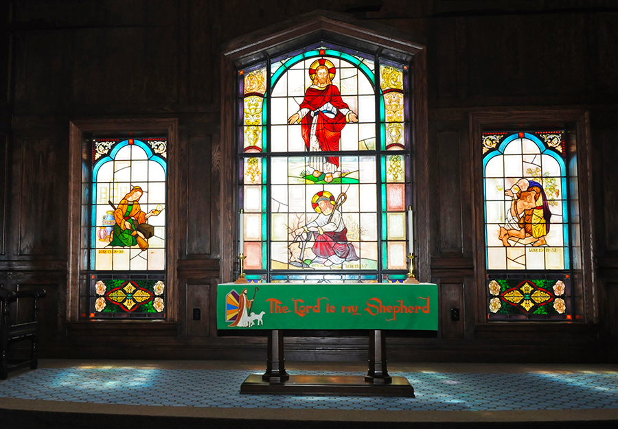 Stained glass windows depicting religious scenes in a church.