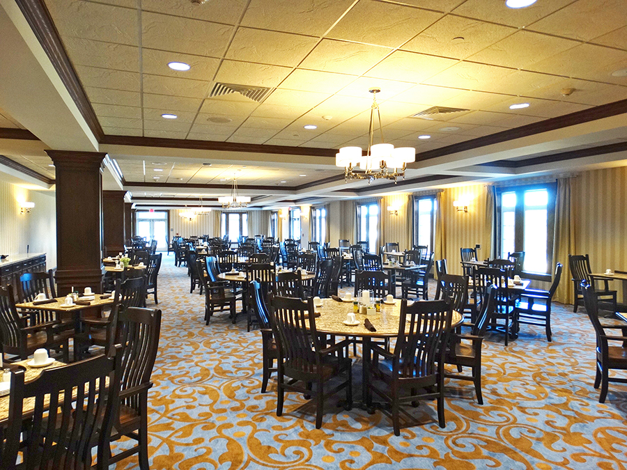 Spacious dining room with numerous tables and chairs.