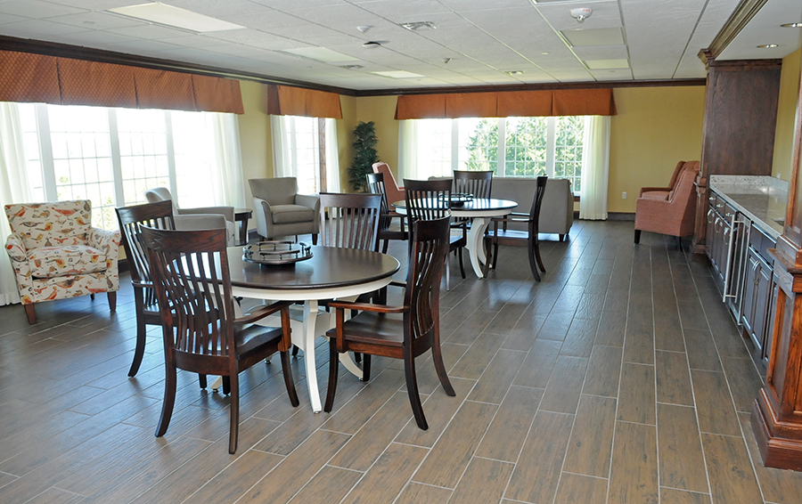 Bright communal space with tables, chairs, and natural light.