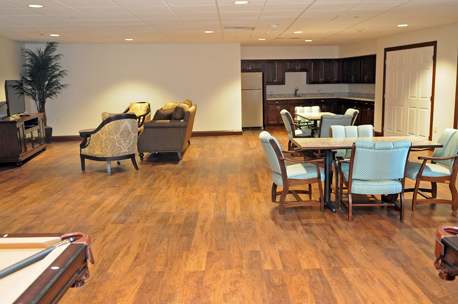 Spacious lounge area with seating and a kitchen.