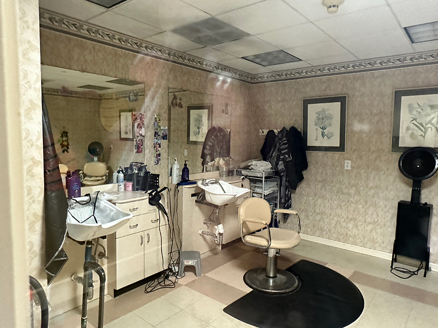 Hair salon with styling chairs and shampoo station.