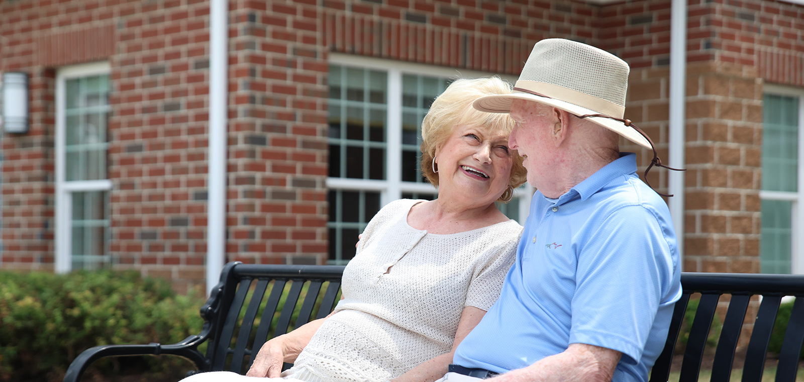 Elderly couple enjoying a joyful moment together outdoors.