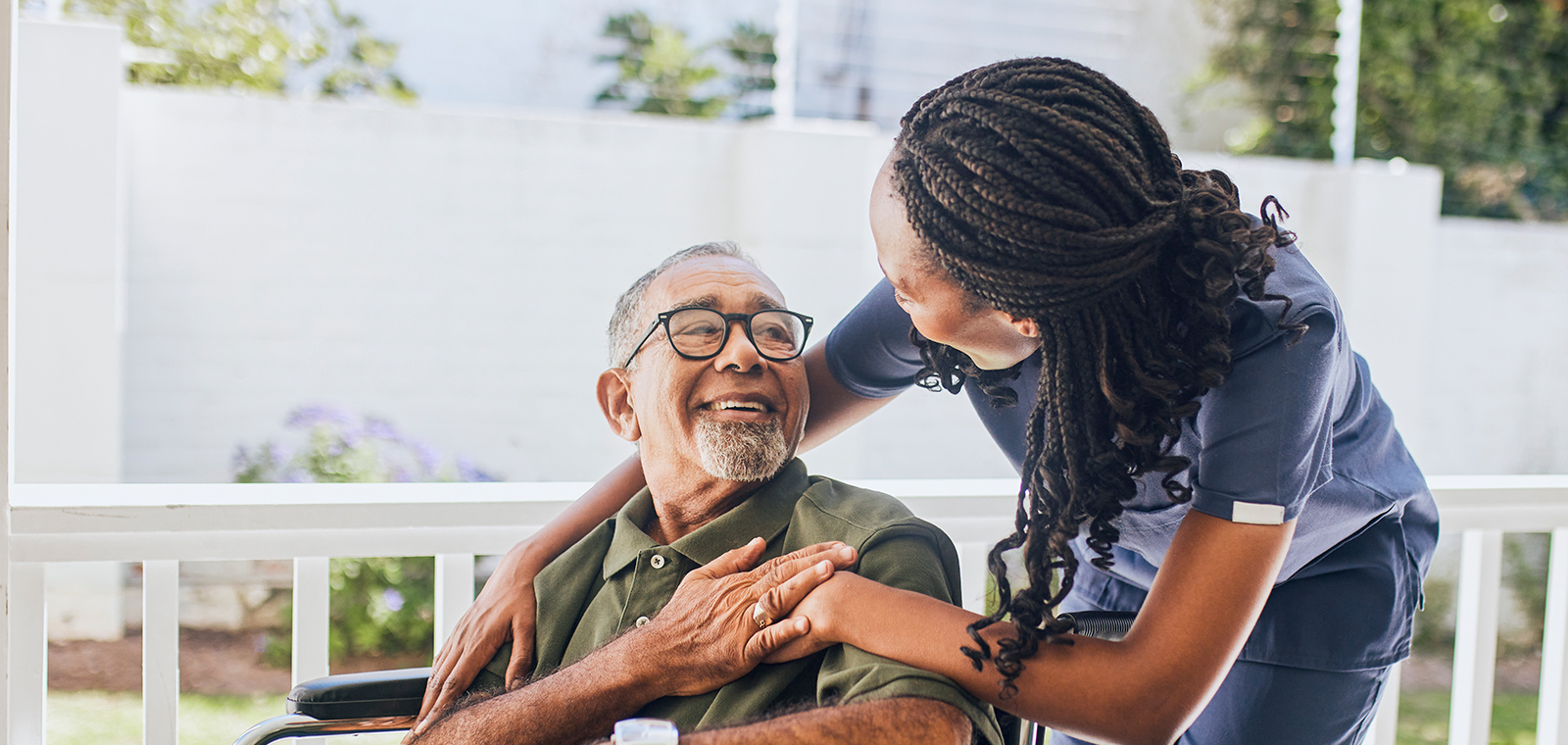 Smiling caregivers share a joyful moment outdoors.