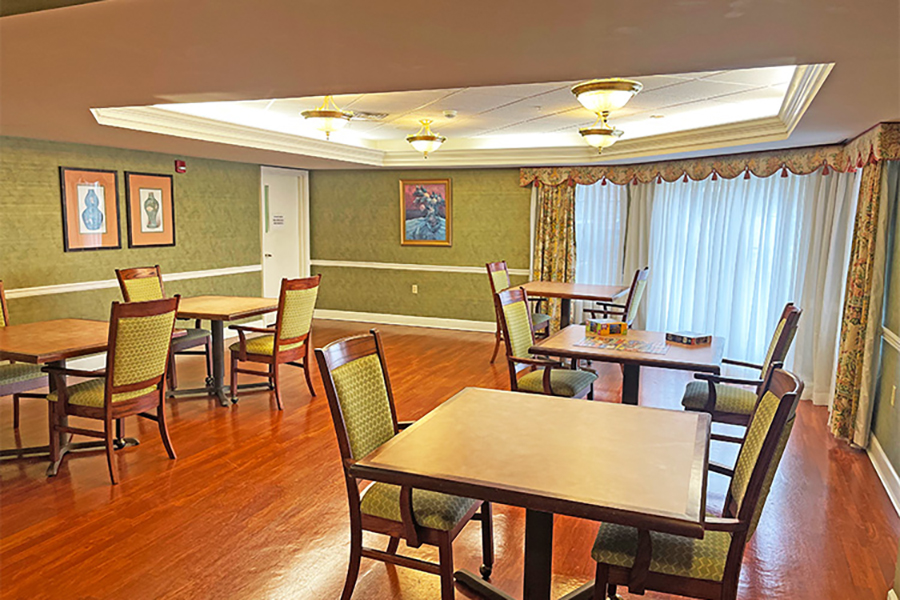 Bright dining area with wooden floors and tables.