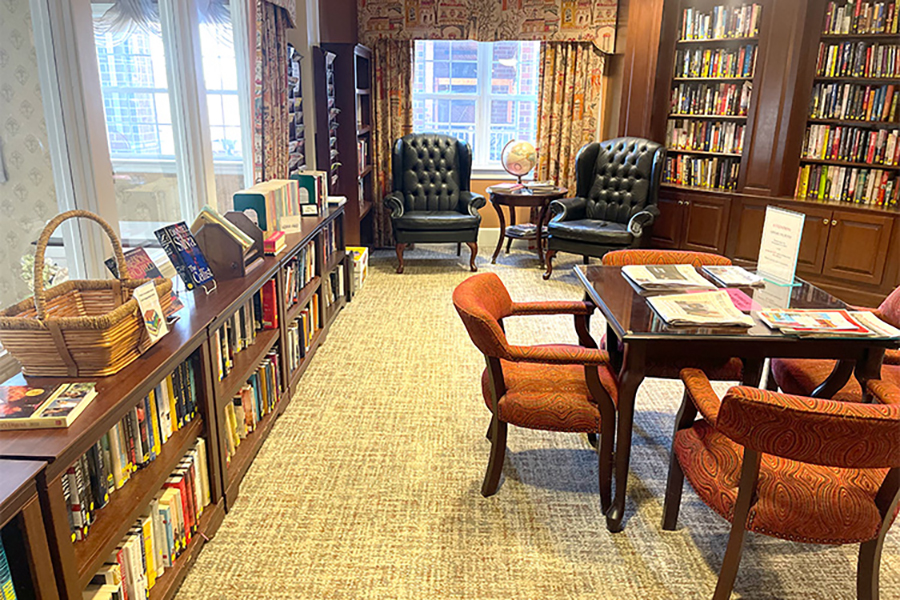 Cozy library with books, seating, and natural light.