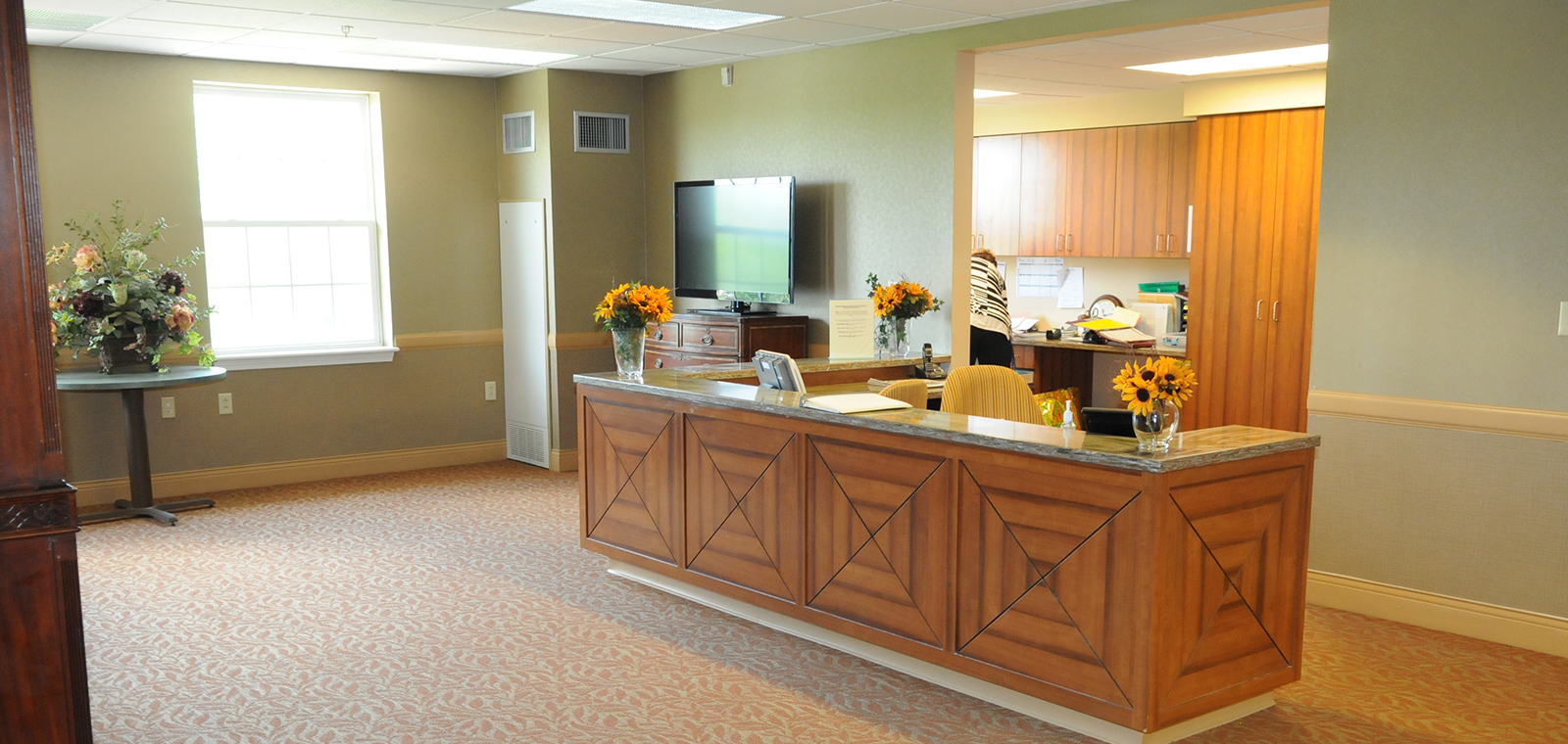 Reception area with flowers and warm interior design.