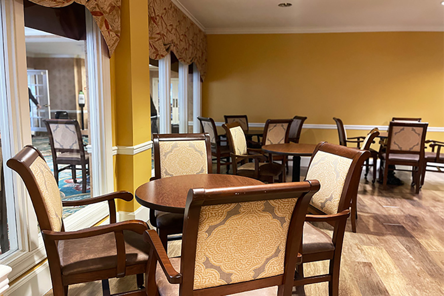 Cozy dining area with wooden tables and chairs.