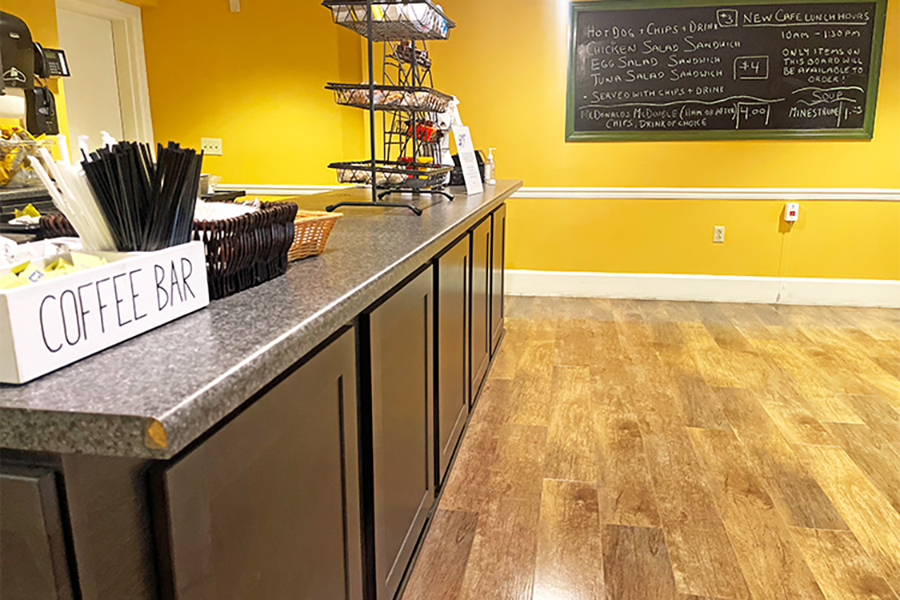 Cafe counter with menu, coffee bar, and yellow walls.