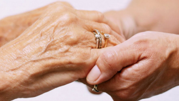 Two hands clasped together, showing connection and care. 