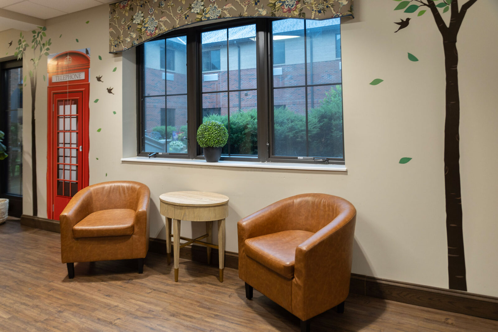 Cozy seating area with decorative wall and window view.
