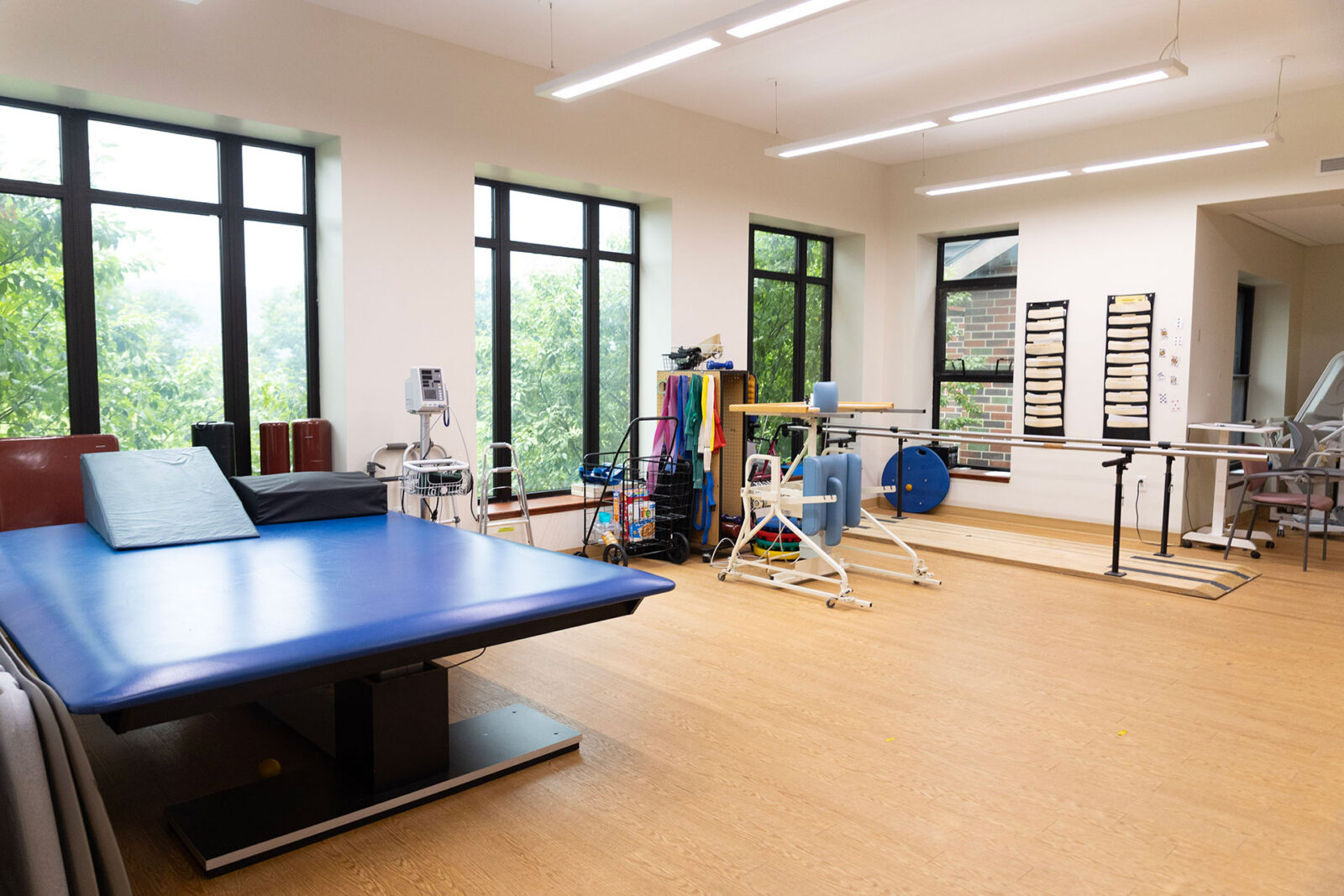Therapy room with exercise equipment and natural light.