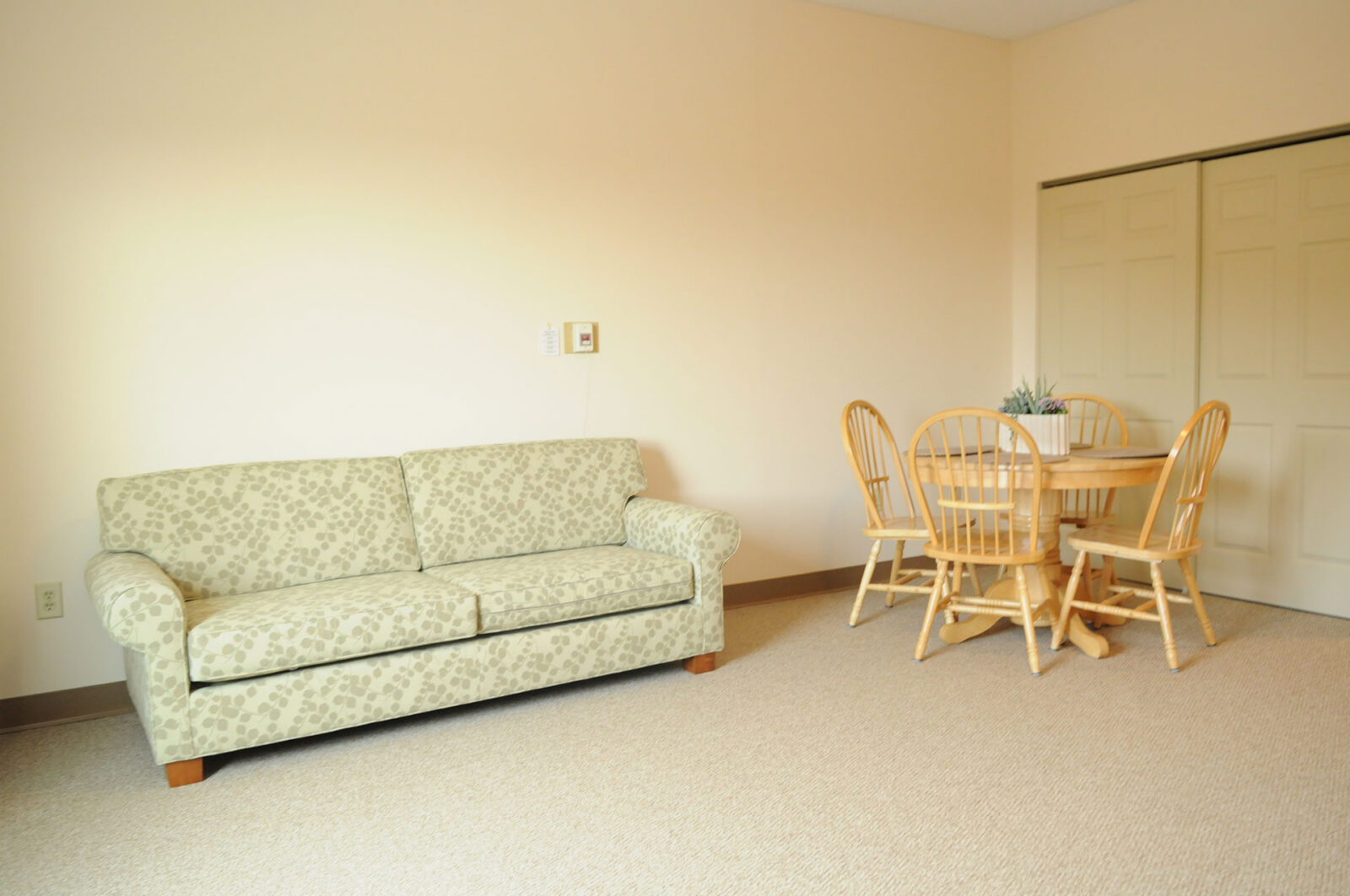 Cozy living space with a sofa and dining table.