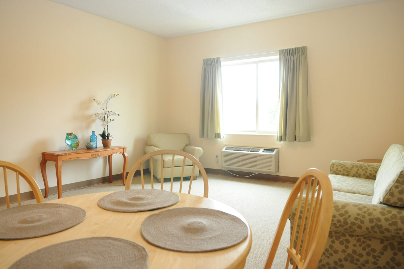 Bright, simple living area with dining table and seating.