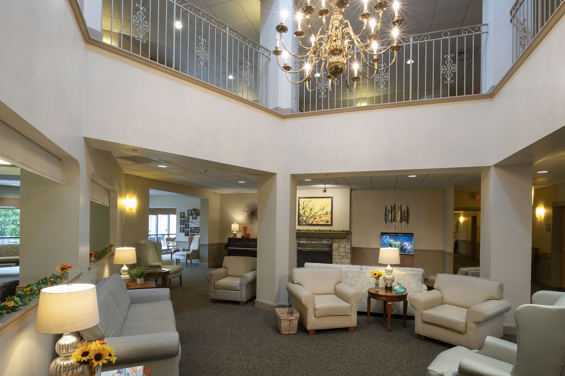 Cozy communal space with chandelier, seating, and decor.
