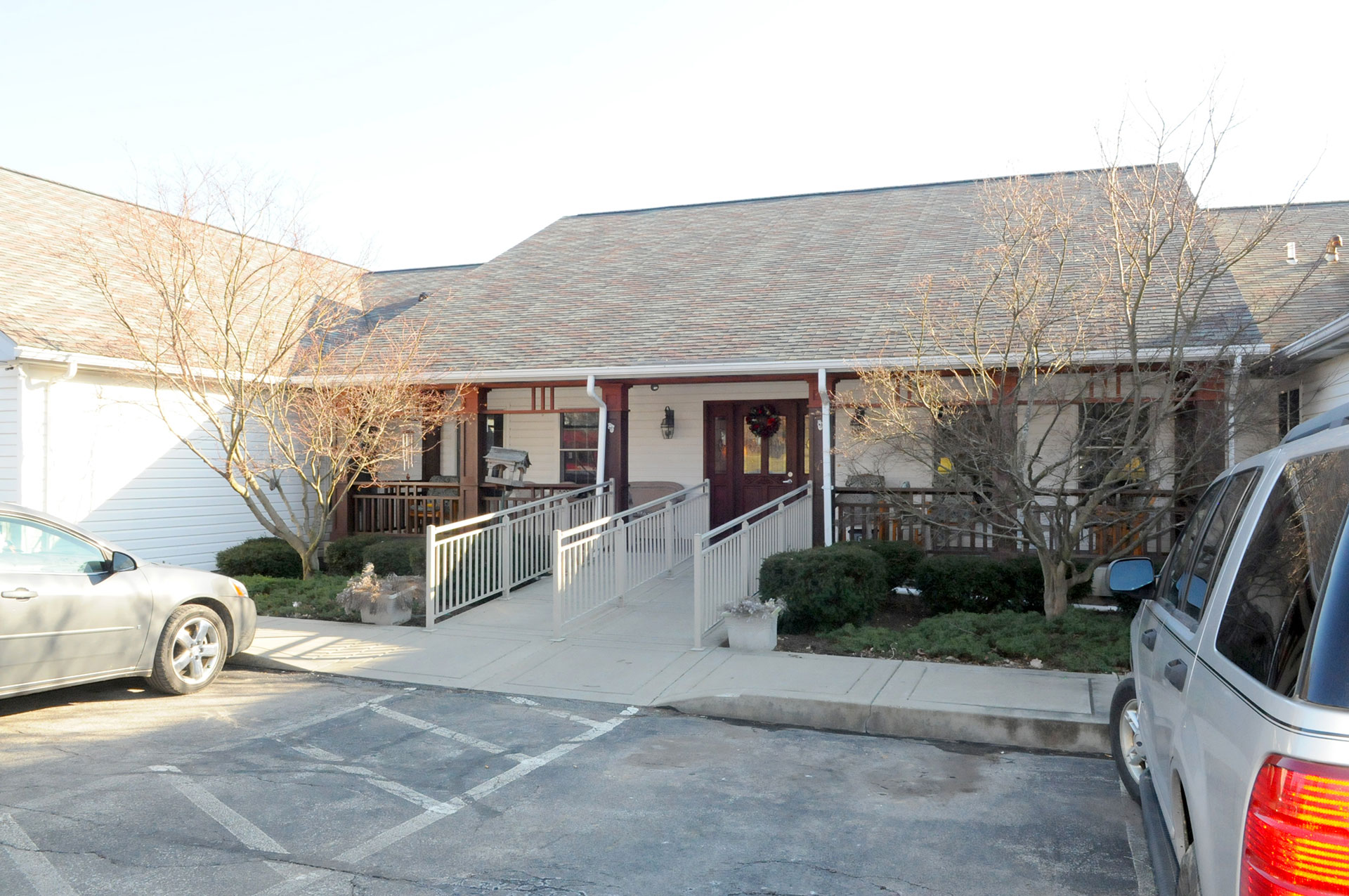 Entrance of a building with accessible ramp and parking.