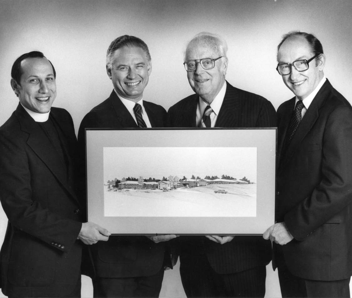Four men holding a picture
