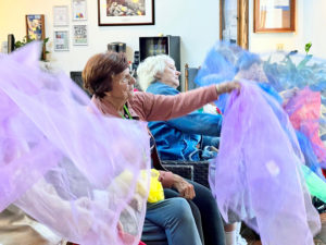 Concordia of Fox Chapel residents fling colorful fabrics as part of a fun exercise. 