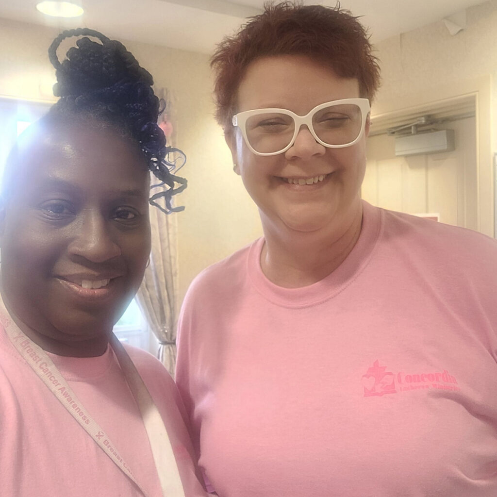 Dawn Butler poses in pink with a colleague.