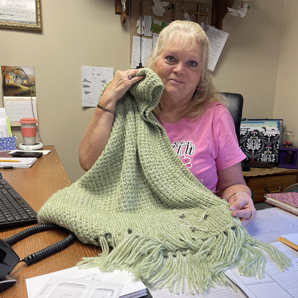A photograph of Janet Bennett and the prayer shawl she received anonymously.