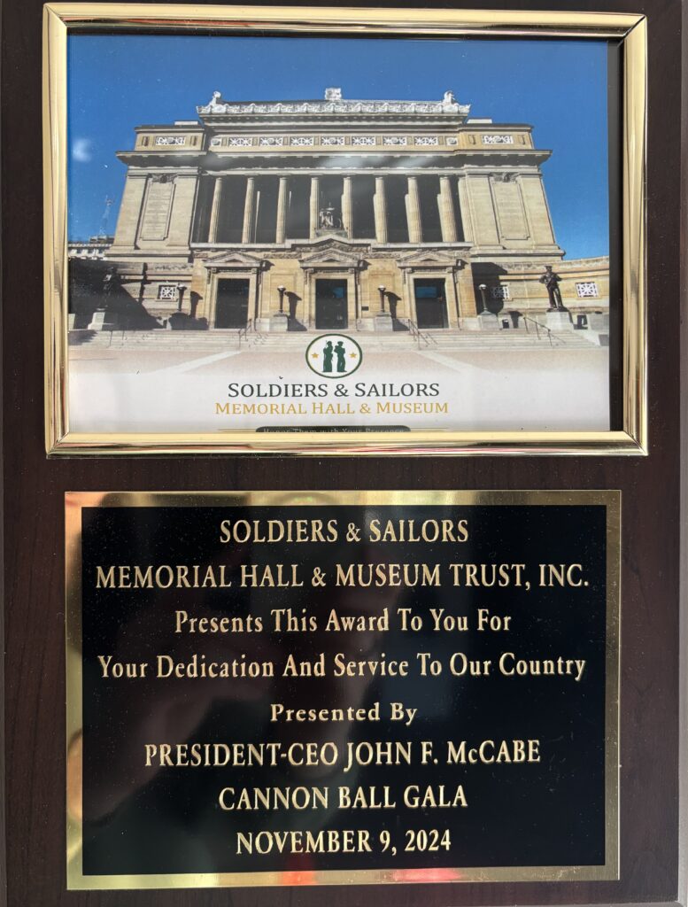 Concordia resident Julia's wooden and gold award from the Soldiers and Sailors Memorial Hall and Museum Trust organization for dedication for service to the US