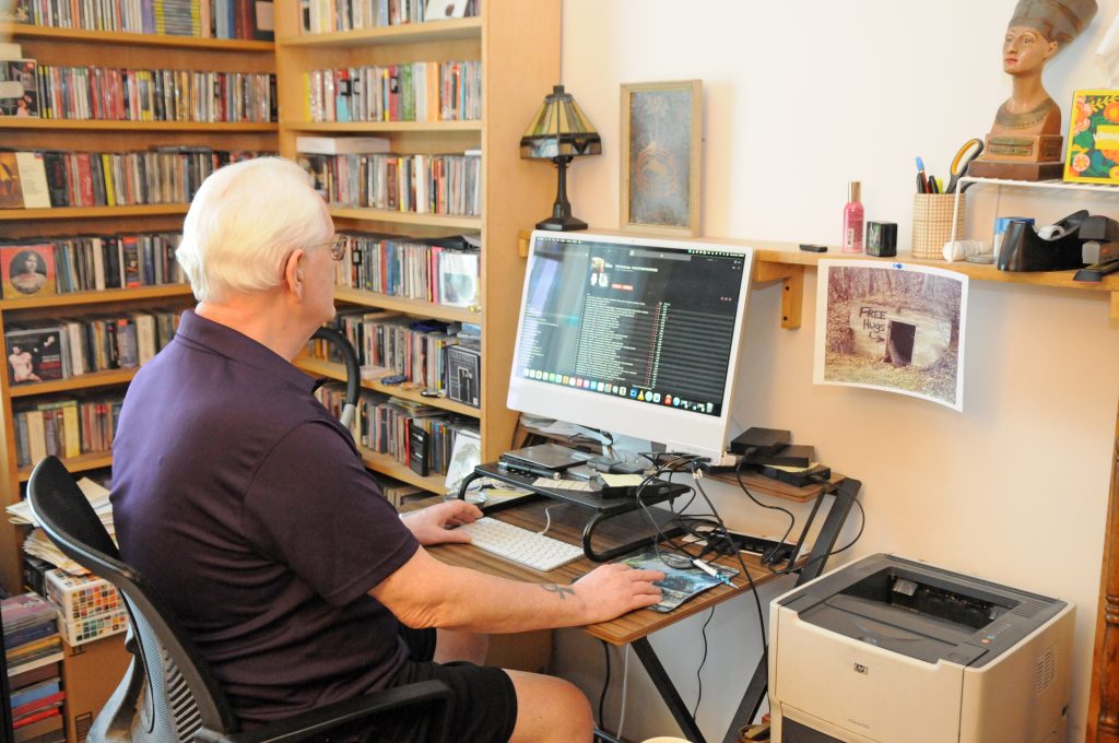Nick Limansky working on his computer in his Concordia retirement living apartment
