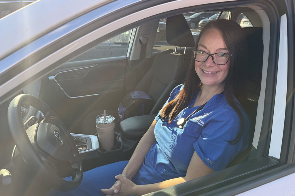 Mya sits in the driver's seat of her CVN car.