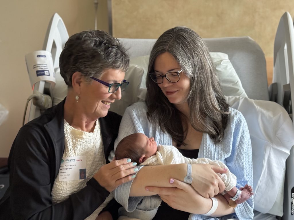 Emily Bitting-Jha holds her baby alongside her own mother Beth Bitting.