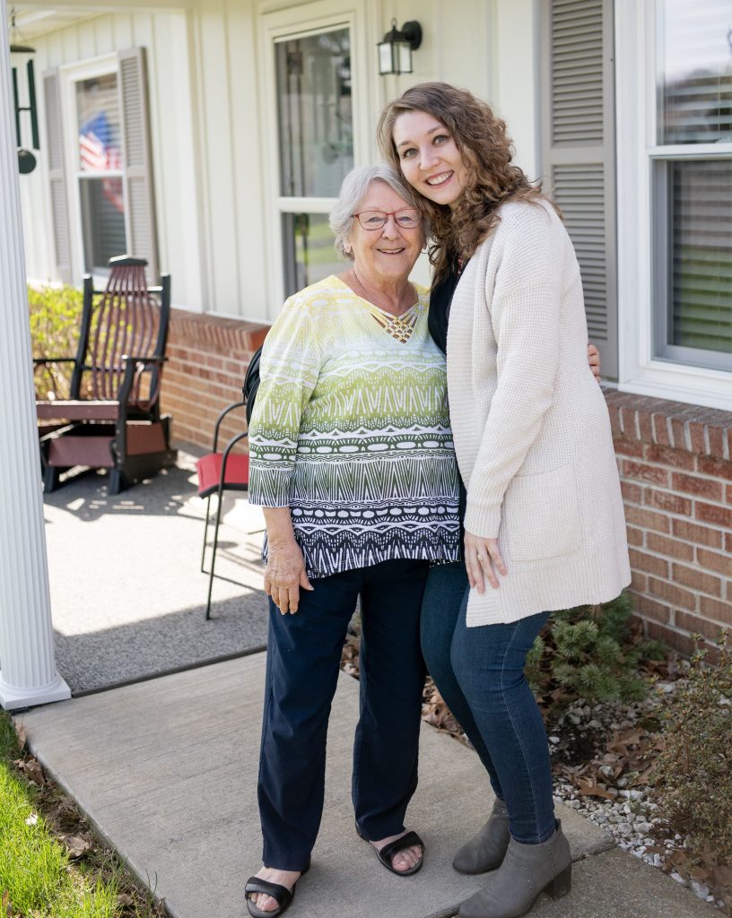 Kelsey Josephson visits with resident Pat Griffith-Hughes outside Pat’s retirement living cottage.