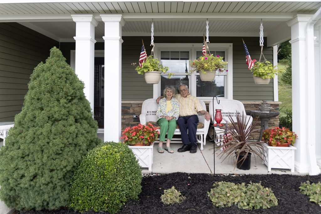 Concordia at Bethlen retirement living residents sitting on the porch of their cottage