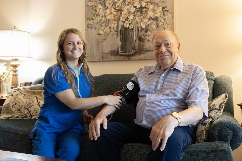 Concordia Visiting Nurses clinician checking a retirement living resident’s blood pressure in his home