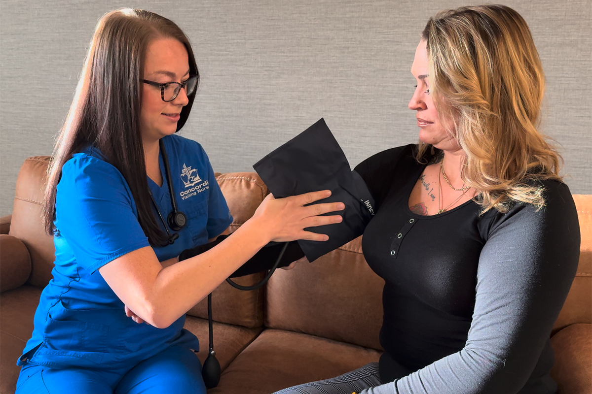 Mya attaches a blood-pressure cuff to a patient's arm.